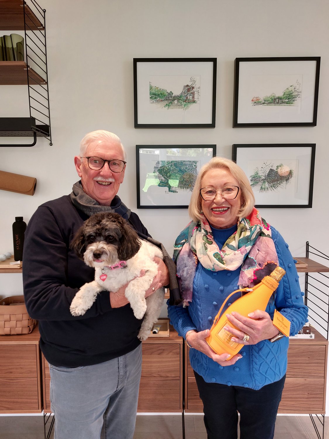 A couple holding their small dog