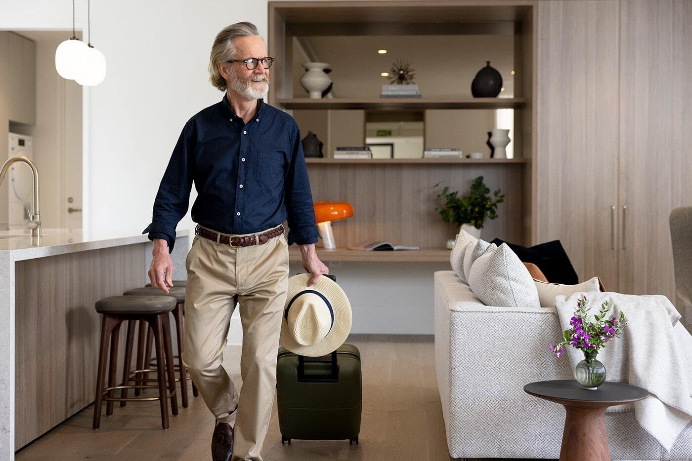 Elderly man walking through lounge room