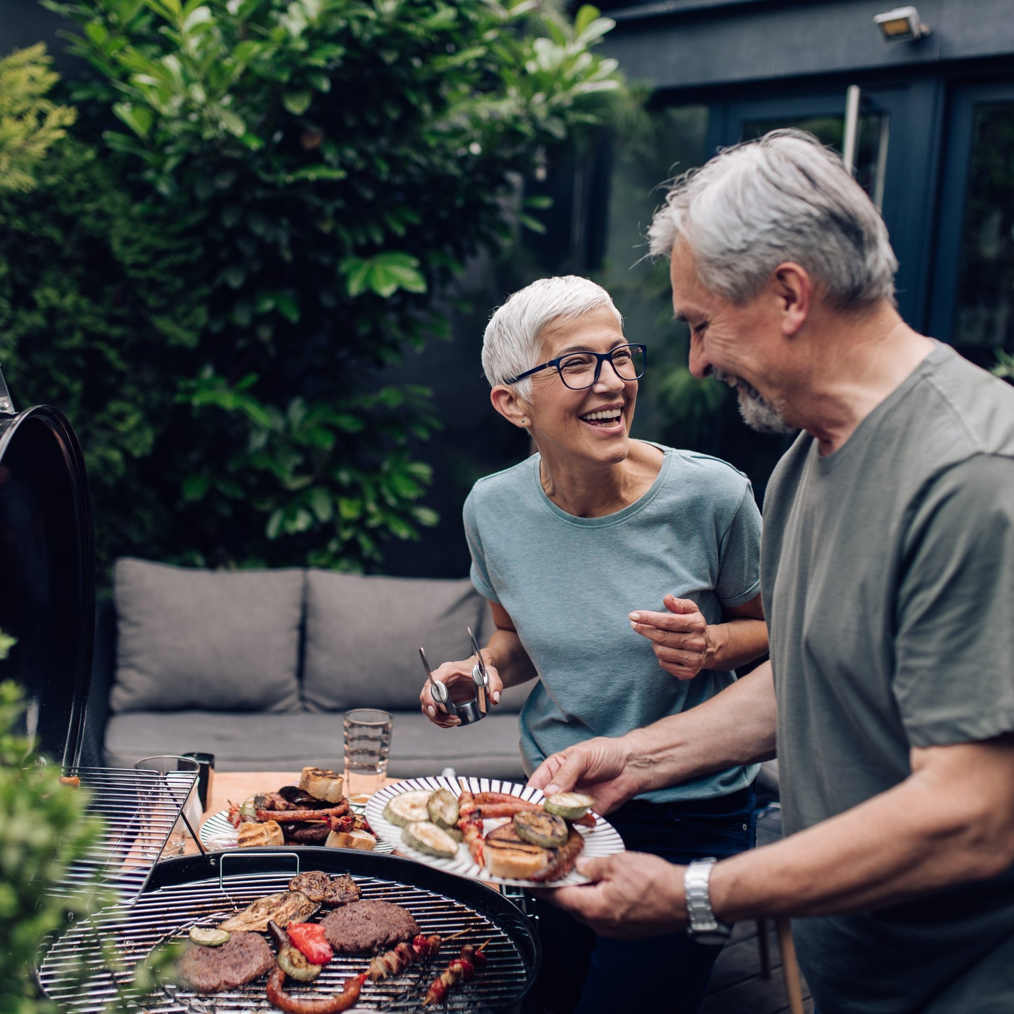 Elderly residents enjoying a BBQ outdoors